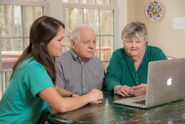 A franchisee studying training material at a computer